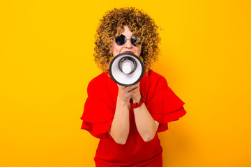 Attractive woman with curly hair with loudspeaker