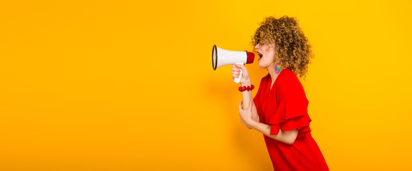 Attractive woman with curly hair with loudspeaker