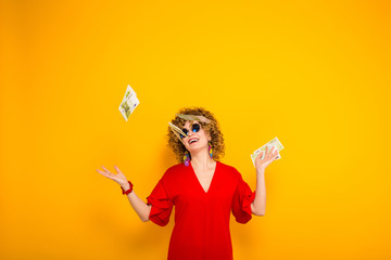 Attractive woman with short curly hair with cash