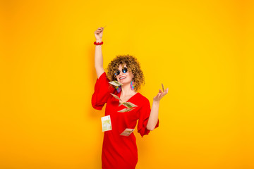 Attractive woman with short curly hair with cash