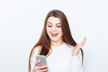 Surprised astonished lady has shocked expression, points with fore finger at copy space on ...