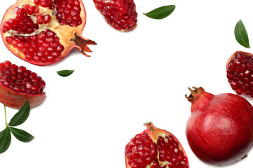 pomegranate fruit with green leaves isolated on a white background top view