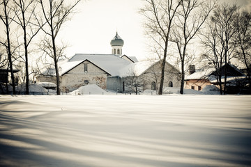 Church behind the snow-covered field
