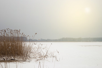 The frozen winter lake in under snow