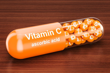 Vitamin C capsule on the wooden table. 3D rendering