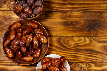 Dried dates fruit on wooden table. Top view