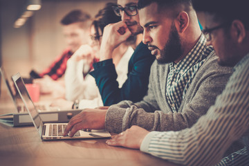 Young colleagues discussing ideas in coworking office.