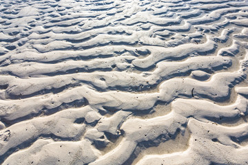 Fototapeta na wymiar Sand texture from waves and wind.