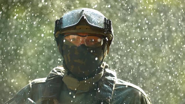 Military man in the rain, slow motion
