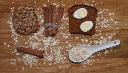 quail eggs on a black bread and oat chips and cookie and a cinnamon stick