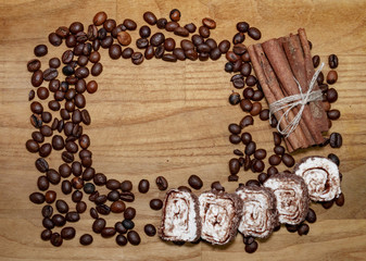 cinnamon stick and coffee beans and turkish delight on a broun wooden table