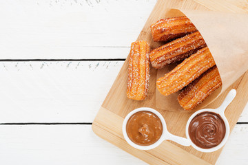 Churros with sugar and chocolate sauce . top view 