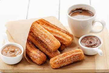 Churros with sugar and chocolate sauce . top view 