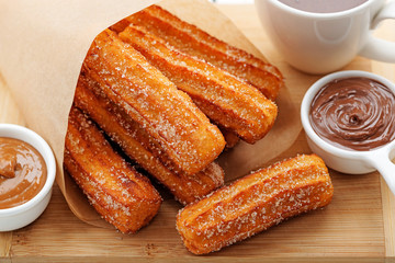 Churros with sugar and chocolate sauce . top view  - 194338950