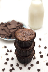 Whole Wheat Double Chocolate Chip Muffins on a Rustic White Wood Table