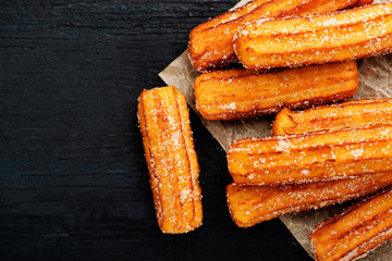 Churros with sugar and chocolate sauce . top view 