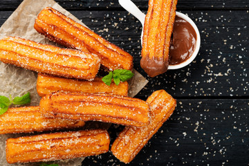 Churros with sugar and chocolate sauce . top view 