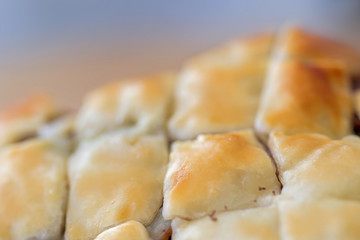 Crust of puff pastry close up.