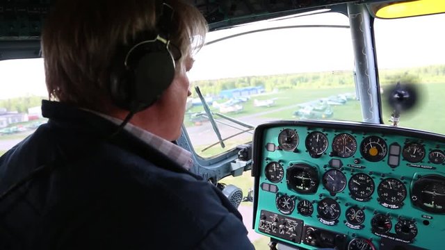 The pilot controls the airplane.