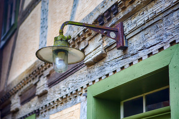 Fototapeta premium streetlamp hanging above old door at vintage house