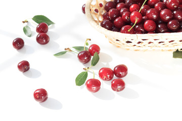 Fresh fruit cherry  in  wicker basket  on white background. Red berry still life
