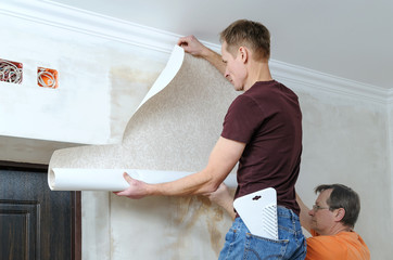 Glueing wallpapers at home.
