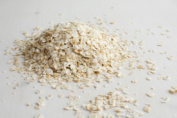 heap of rolled oats on a white background