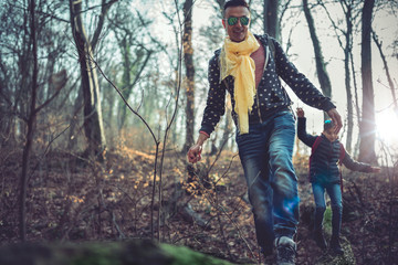 Father and daughter hiking in the forest