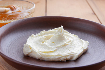 Sour cream, cream, fresh sour cream in pottery on a wooden background, dairy products and honey, wooden board, French breakfast, healthy food, sour cream and honey in a rustic style, minimalism, copy 