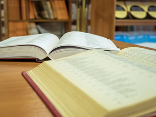 two opened books on the table reading in the university library