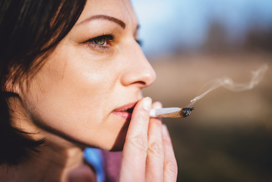 Portrait of women smoking outdoors