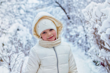 Fototapeta na wymiar Portrait Beautiful little girl on cold winter day. place for text