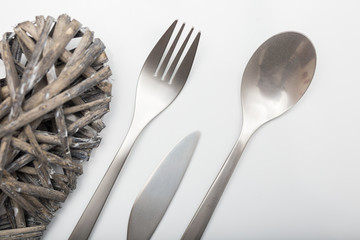 Metal inox cutlery on bright gray table