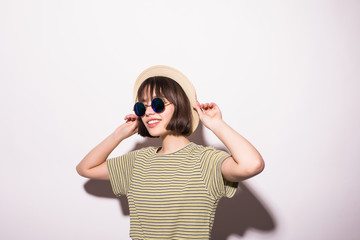 Attractive teen hipster girl in hat, sunglasses isolated on white background