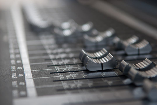 Close up professional studio mixing console fader in grey