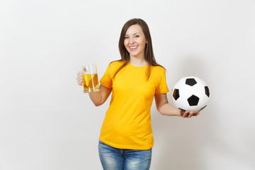 Beautiful European young cheerful woman, football fan or player in yellow uniform holding pint mug of beer, soccer ball isolated on white background. Sport, play football, healthy lifestyle concept.