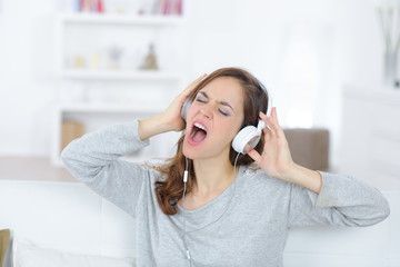 young beautiful brunette girl having fun listening to metal music