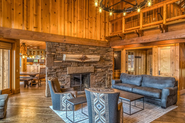 Upscale rustic living room with stone fireplace