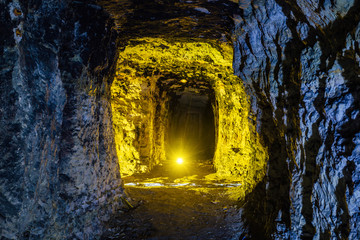 Fototapeta premium Abandoned and collapsed sandstone or limestone mine illuminated by color lights