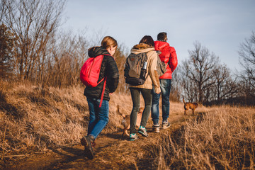 Family hiking at mountain with dog