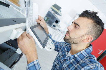 young man learning to use new printer