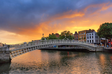Ireland, Dublin, Halfpenny bridge and Liffey river at sunset