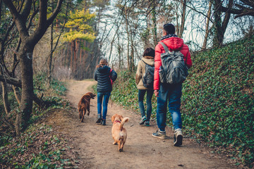 Family with dog hiking at mountain trail