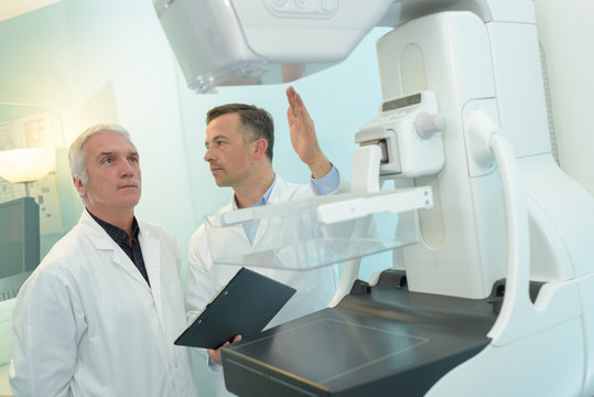 doctor instructing medical staff about ct scanner procedure