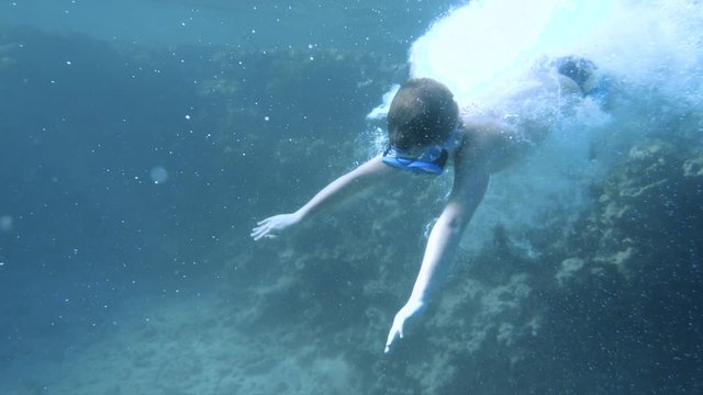 Boy dive in the Red sea with underwater mask