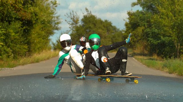 Longboarders with helmets, slow motion