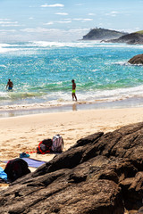  the beach near the rocks in the wave of  ocean