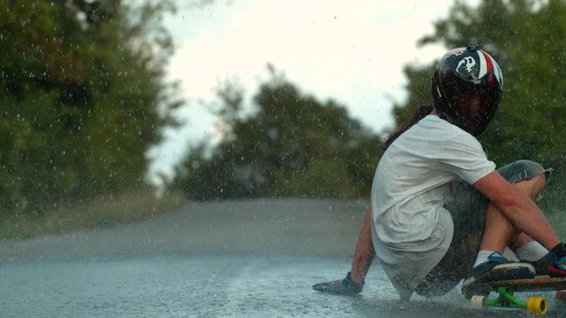 Longboarding in the rain, slow motion
