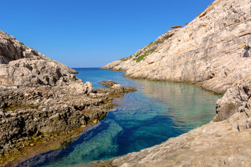Fototapeta na wymiar Small bay with crystal sea water. Korakonisi Island on western side of Zakynthos. Zante, Greece