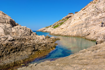 Fototapeta na wymiar Small bay with crystal sea water. Korakonisi Island on western side of Zakynthos. Zante, Greece